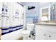 Bright bathroom features a shower/tub combo with blue accents, perfect for a or guest at 6031 Hitt Lake Ct, Stone Mountain, GA 30087