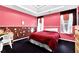 Bedroom with red walls, neutral carpet, natural lighting, and cozy bed that is perfect for a guest or space at 6031 Hitt Lake Ct, Stone Mountain, GA 30087