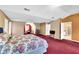 Expansive bedroom featuring ample space, plush red carpet, and natural lighting at 6031 Hitt Lake Ct, Stone Mountain, GA 30087