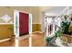 Welcoming foyer with hardwood floors, a red front door, and a staircase at 6031 Hitt Lake Ct, Stone Mountain, GA 30087