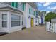 Two-story home with a yellow front door, green shutters, and a patio area at 6031 Hitt Lake Ct, Stone Mountain, GA 30087