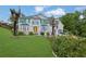 Beautiful two-story home with vibrant green shutters, a manicured lawn, and lush landscaping at 6031 Hitt Lake Ct, Stone Mountain, GA 30087