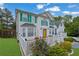 Charming two-story home featuring a bright yellow front door, green shutters, and a well-manicured front yard at 6031 Hitt Lake Ct, Stone Mountain, GA 30087