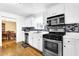 Modern kitchen with white cabinets, stainless steel appliances, and stylish backsplash at 6031 Hitt Lake Ct, Stone Mountain, GA 30087