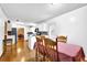 Bright kitchen with white cabinetry open to a dining area; hardwood flooring at 6031 Hitt Lake Ct, Stone Mountain, GA 30087