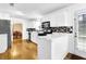 Clean kitchen with white cabinets, modern appliances, and views of dining and living area at 6031 Hitt Lake Ct, Stone Mountain, GA 30087