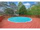 Inviting outdoor swimming pool surrounded by a red wooden deck at 6031 Hitt Lake Ct, Stone Mountain, GA 30087