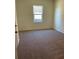 Cozy carpeted bedroom with a view of a tree-lined landscape at 7785 Sudbury Cir, Covington, GA 30014