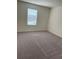 This bedroom features plush carpet flooring and a window that provides natural light at 7785 Sudbury Cir, Covington, GA 30014