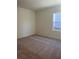 Bright bedroom with plush carpeting and a window at 7785 Sudbury Cir, Covington, GA 30014