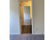 This hallway features plush carpet flooring and provides access to the bedroom at 7785 Sudbury Cir, Covington, GA 30014