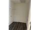 The laundry room features gray wood floors, a white shelf, and washer hookups at 7785 Sudbury Cir, Covington, GA 30014