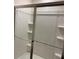 The shower features a sliding glass door and built in shelving at 7785 Sudbury Cir, Covington, GA 30014
