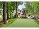Backyard putting green, hot tub, and expansive lawn offer ample space for outdoor activities at 10000 Groomsbridge Rd, Johns Creek, GA 30022