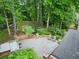 The backyard has a putting green, a patio with chairs, hot tub, and mature trees for privacy at 10000 Groomsbridge Rd, Johns Creek, GA 30022
