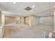 Large basement area with ample room, recessed lighting, neutral carpeting and access to other areas of the home at 10000 Groomsbridge Rd, Johns Creek, GA 30022