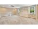 Expansive basement area with recessed lighting, neutral carpeting, built-in shelving, and ample room for recreation at 10000 Groomsbridge Rd, Johns Creek, GA 30022