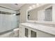 Contemporary bathroom with a glass-enclosed shower, marble vanity and unique black and white floor tiles at 10000 Groomsbridge Rd, Johns Creek, GA 30022