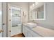 Updated bathroom features a square vessel sink, neutral countertops, and a tiled shower with glass door at 10000 Groomsbridge Rd, Johns Creek, GA 30022