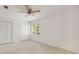 Bright bedroom with a ceiling fan, large window, and a closet, offering a comfortable and private space at 10000 Groomsbridge Rd, Johns Creek, GA 30022