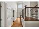 Bright foyer with hardwood floors, a staircase, and a front door with sidelights and transom at 10000 Groomsbridge Rd, Johns Creek, GA 30022