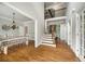 Open-concept foyer with hardwood floors connecting the dining room, staircase, and entry area at 10000 Groomsbridge Rd, Johns Creek, GA 30022