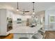 Bright and airy kitchen featuring a large kitchen island with seating, stainless steel appliances, and white cabinetry at 10000 Groomsbridge Rd, Johns Creek, GA 30022