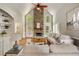 Bright living room with vaulted ceilings, large stone fireplace, and lots of natural light at 10000 Groomsbridge Rd, Johns Creek, GA 30022