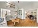 Spacious living room with hardwood floors, built-in shelving, and open floor plan to the dining room at 10000 Groomsbridge Rd, Johns Creek, GA 30022