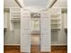 Walk-in closet leads to a luxurious bathroom, providing ample storage and convenience at 10000 Groomsbridge Rd, Johns Creek, GA 30022
