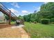 A backyard with a grill, wooden staircase, and lush greenery at 120 Laurel Rdg, Canton, GA 30114