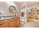Bathroom with a vanity, round mirror, and a decorative wall mural for an artistic touch at 120 Laurel Rdg, Canton, GA 30114