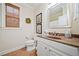 Bathroom with a granite countertop sink, floral decor, and a window with woven shades at 120 Laurel Rdg, Canton, GA 30114