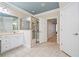 Bright bathroom featuring a glass shower, double vanity with sink, and a doorway leading to the hall at 120 Laurel Rdg, Canton, GA 30114
