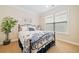 Cozy bedroom with a wrought iron bed, a window, and a potted plant in the corner at 120 Laurel Rdg, Canton, GA 30114