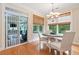Cozy dining area with a round table, bright lighting, and access to a screened porch at 120 Laurel Rdg, Canton, GA 30114