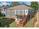 Multi-story home featuring a screened in porch, back yard, wooden stairs, and a barbeque grill at 120 Laurel Rdg, Canton, GA 30114