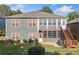 Backyard with a two-story home, lots of windows, a screened in porch, stairs, and a grill at 120 Laurel Rdg, Canton, GA 30114