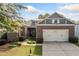 Charming brick home with a two-car garage, manicured lawn, and beautiful landscaping at 120 Laurel Rdg, Canton, GA 30114