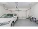 Clean garage with a parked car, bikes, and an automatic door opener at 120 Laurel Rdg, Canton, GA 30114