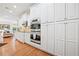 Beautiful chef's kitchen featuring custom cabinets, stainless appliances, and hardwood flooring at 120 Laurel Rdg, Canton, GA 30114