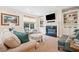 Comfortable living room features a fireplace, built-in shelving, and a large window at 120 Laurel Rdg, Canton, GA 30114