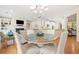 Open-concept living room featuring a dining area, fireplace, and seamlessly connected to a modern kitchen at 120 Laurel Rdg, Canton, GA 30114