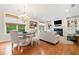 Bright open living room with fireplace, wood floors, and adjacent dining area with a chandelier at 120 Laurel Rdg, Canton, GA 30114