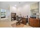 Home office with a desk, rolling chair, bookshelf, and a large window with natural light at 120 Laurel Rdg, Canton, GA 30114