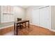 Office area with hardwood floors, a desk, a rolling chair, and white sliding-door closet at 120 Laurel Rdg, Canton, GA 30114