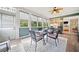 Inviting sunroom featuring ample windows, a ceiling fan, and a dining table for relaxing or entertaining at 120 Laurel Rdg, Canton, GA 30114