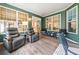 A well lit sunroom with recliners with access to other rooms within the house at 120 Laurel Rdg, Canton, GA 30114