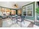 The sunroom has a ceiling fan and windows that let in a lot of natural light at 120 Laurel Rdg, Canton, GA 30114