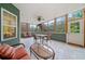 Enclosed sunroom with tile flooring, lots of natural light, and a ceiling fan for added comfort at 120 Laurel Rdg, Canton, GA 30114
